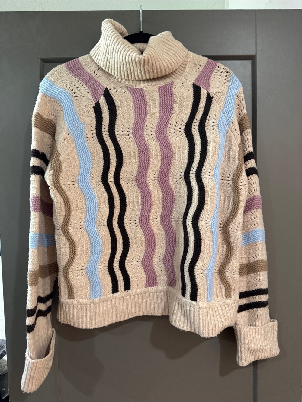 Beige Wave-Stripe Turtleneck Sweater with Pastel Accents